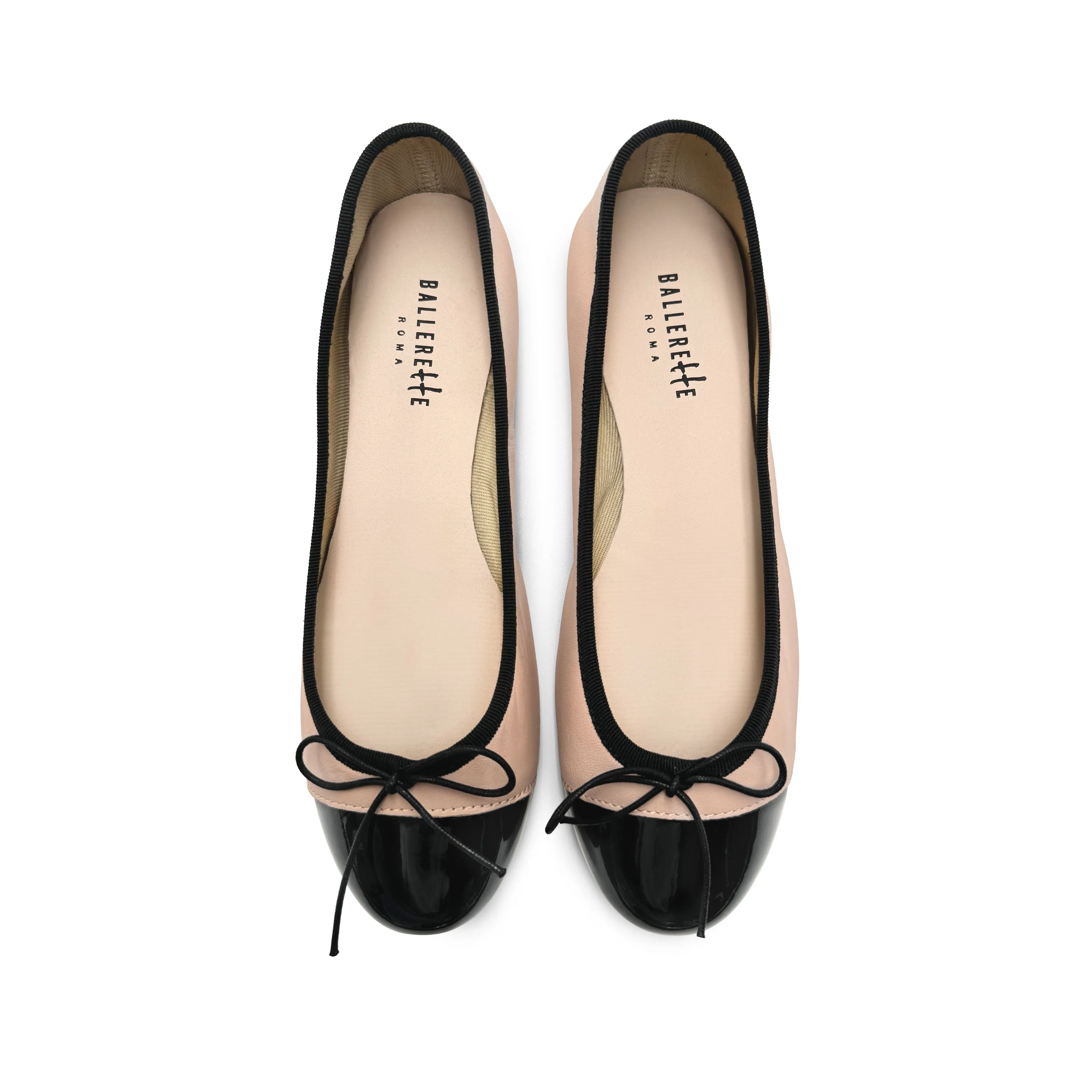 Blush pink leather ballet flats with black patent toe